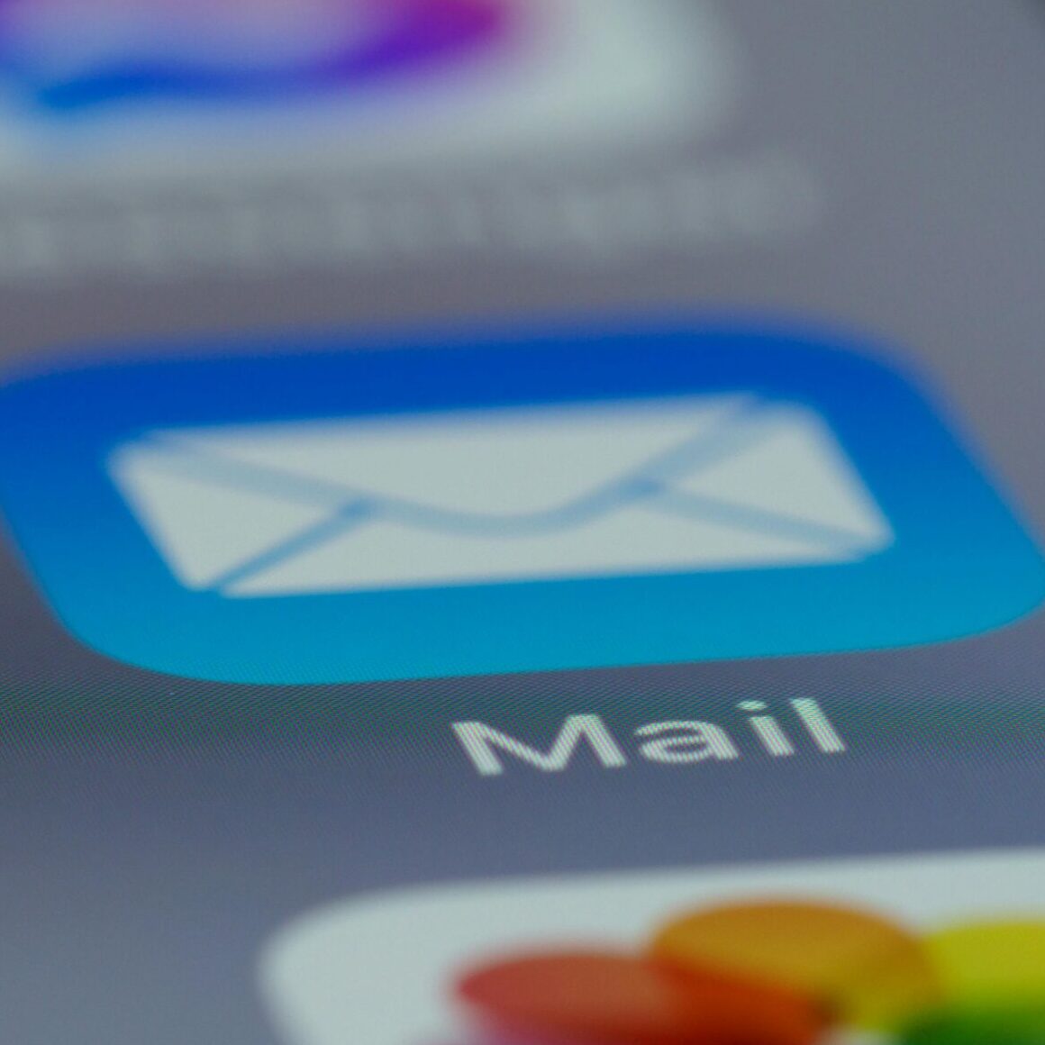 Detailed close-up of an email app icon on a smartphone screen, showcasing modern technology.